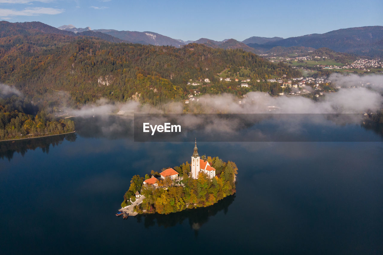 Panoramic view of lake and buildings against sky