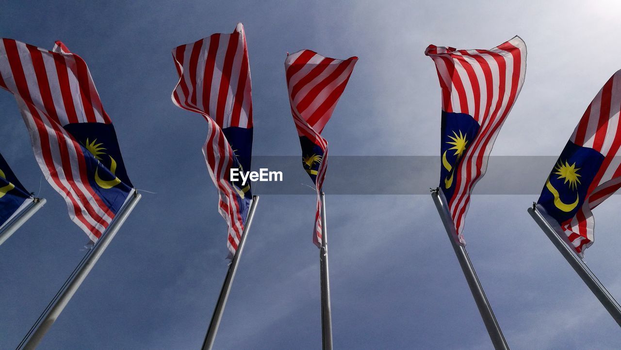 Low angle view of malaysian flags on poles