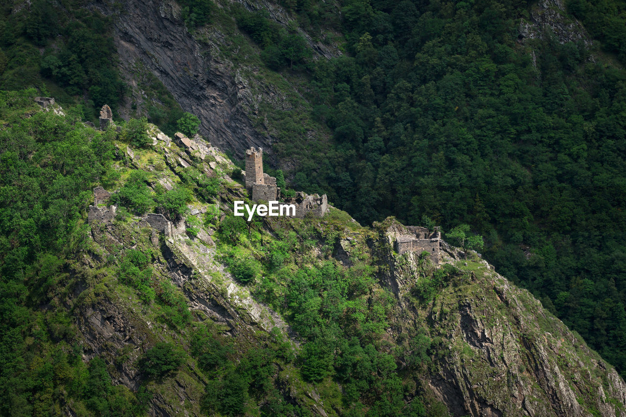 Ancient historical towers in the mountains of chechnya. aerial view of mountain range