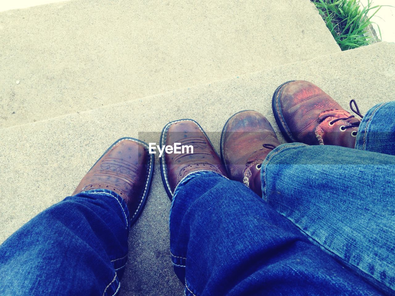 Low section of men feet with boots on steps