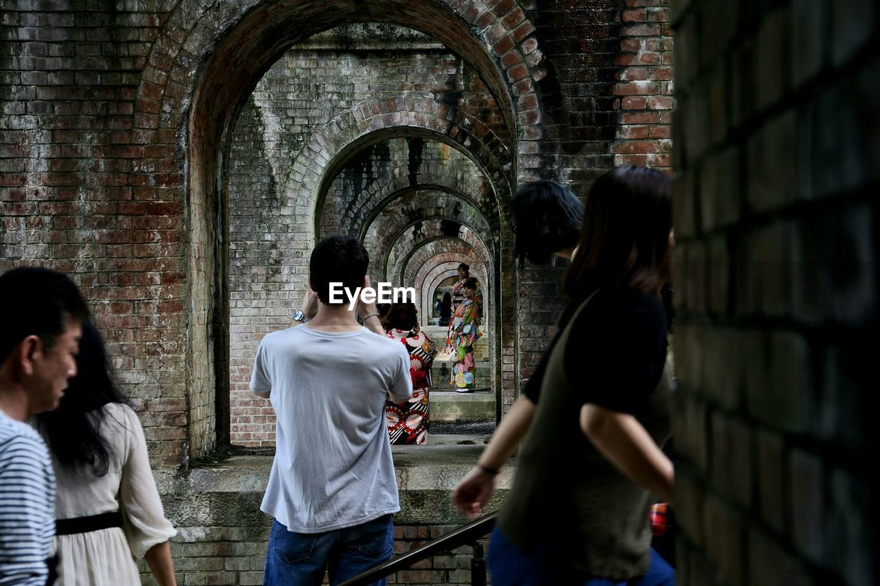 PEOPLE LOOKING AT CHURCH IN FRONT OF HISTORIC CATHEDRAL