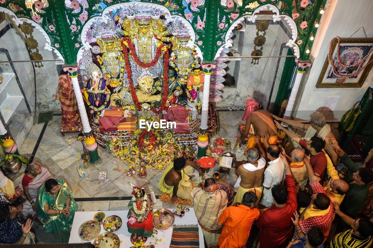 High angle view of people praying in temple
