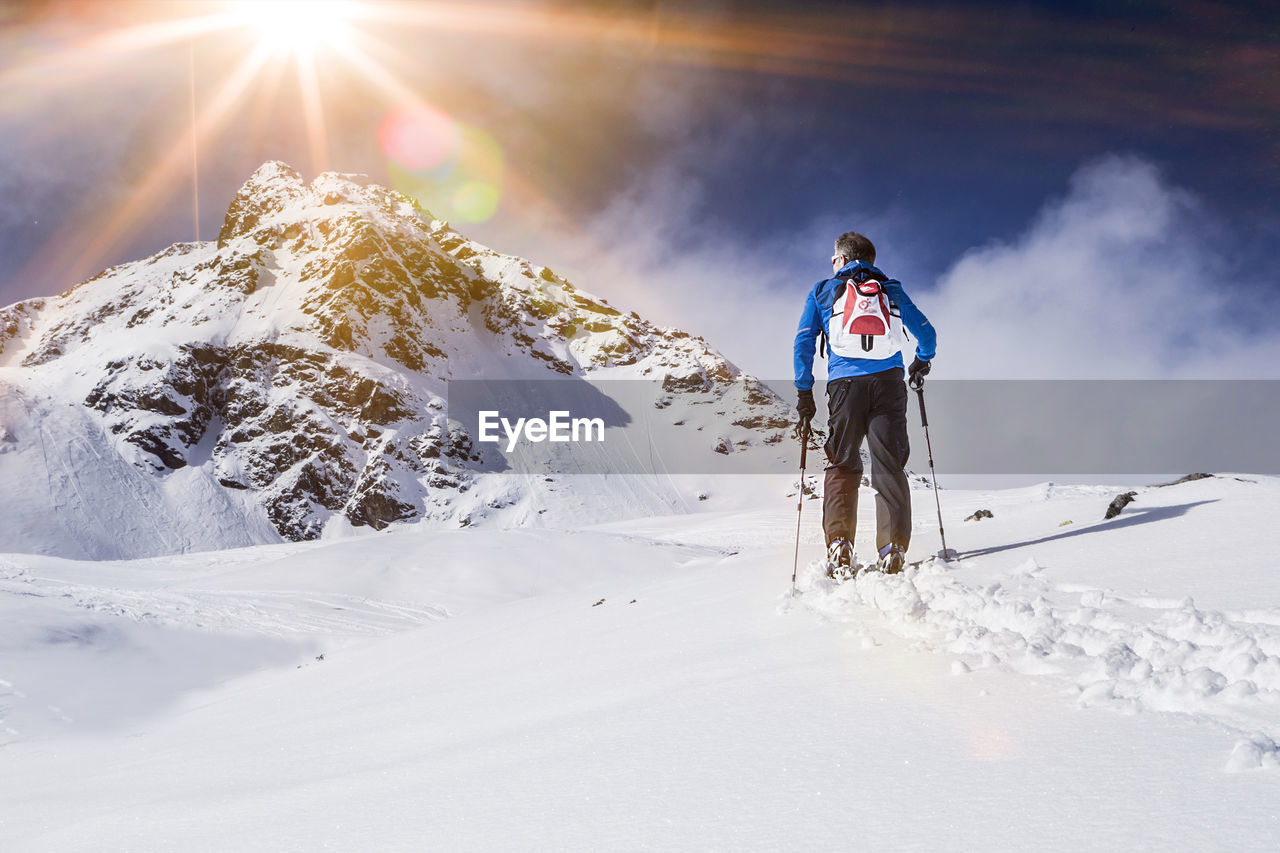 Full length of man standing on snow covered landscape