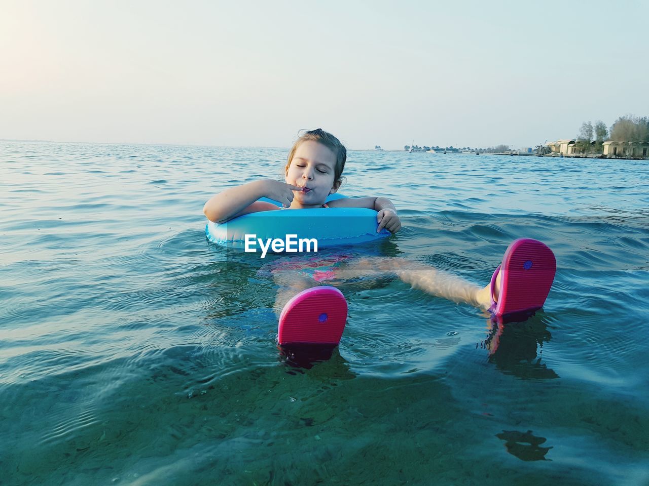 Girl with inflatable ring in sea