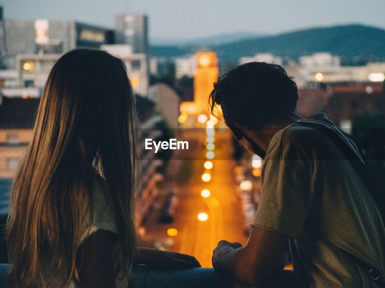 Young couple looking at view from balcony