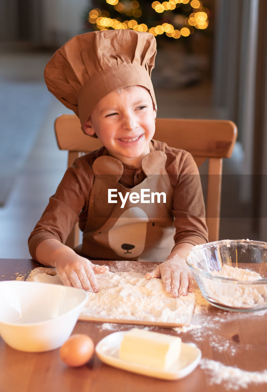 Cute boy preparing cookies at home