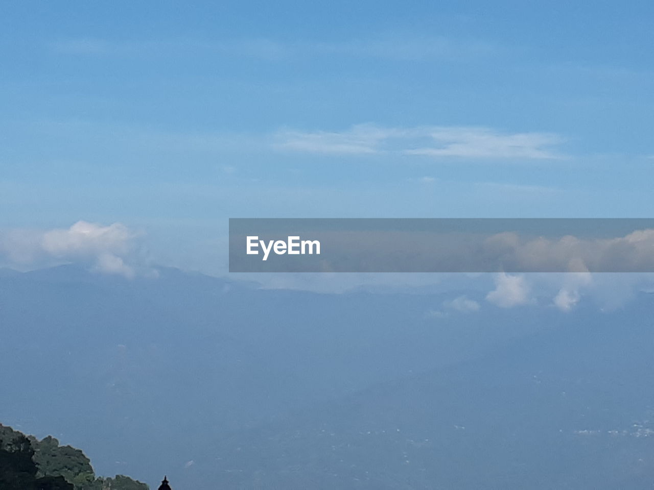 SCENIC VIEW OF CLOUDS OVER MOUNTAINS