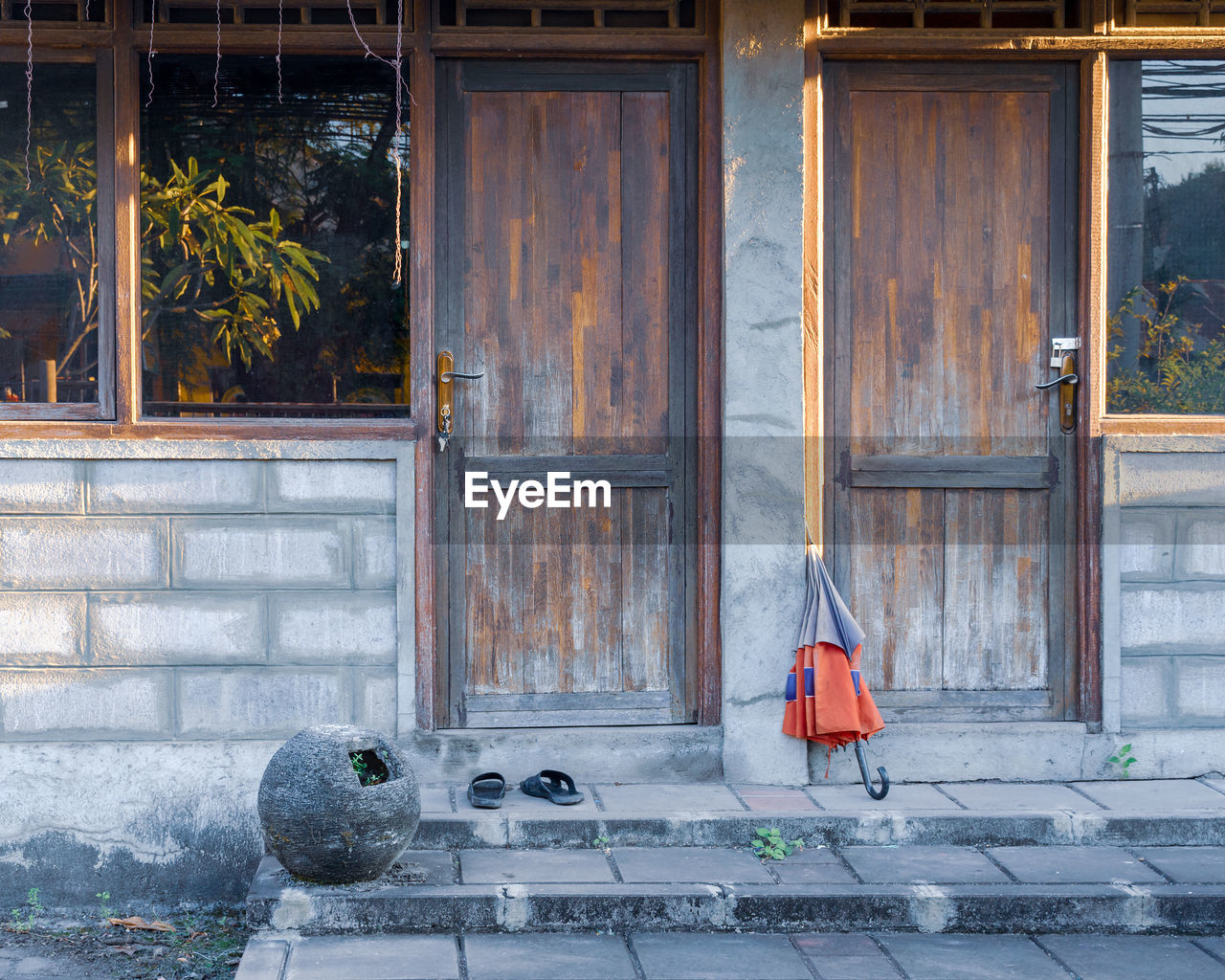 Two wooden entrance doors in a poor village house.