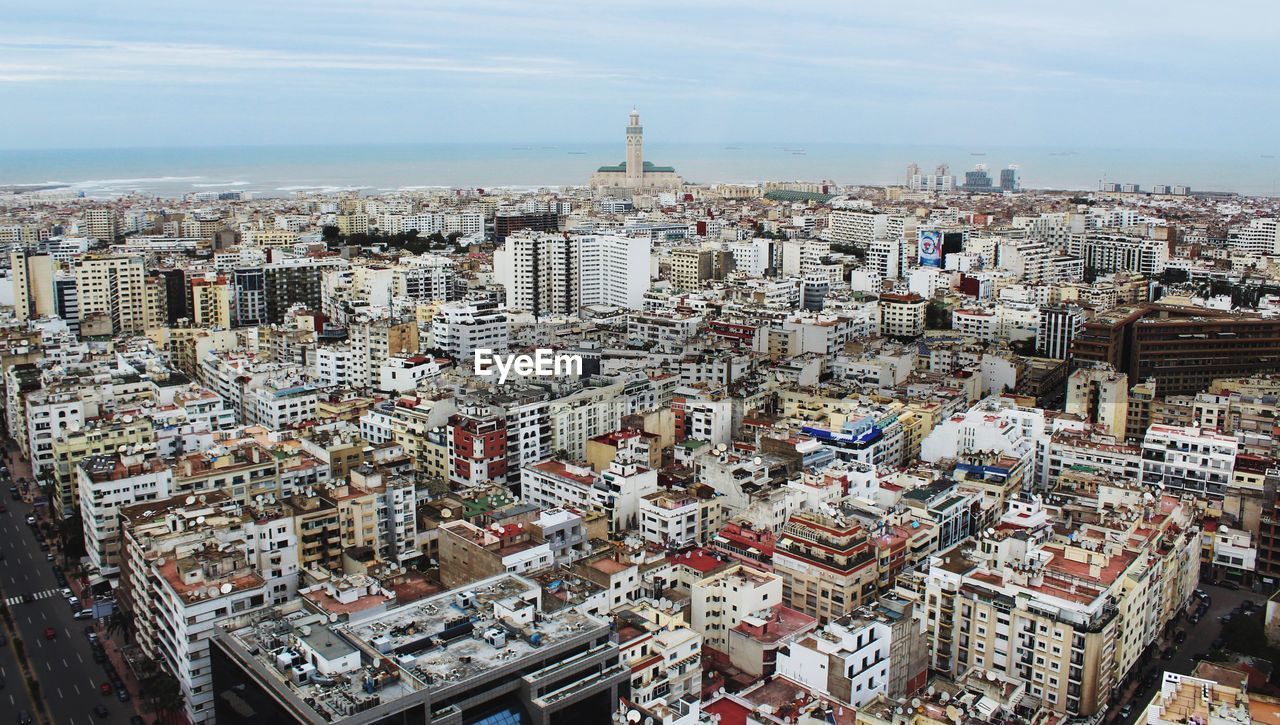 High angle view of modern buildings in city against sky