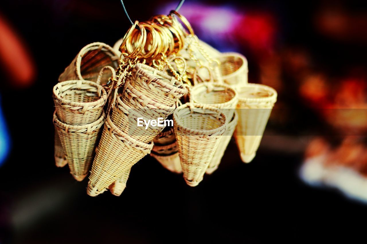 Close-up of wicker baskets decorations for sale at night