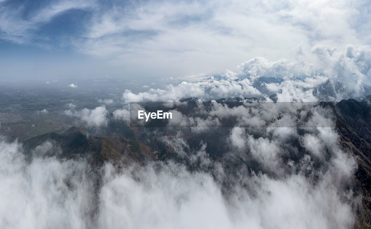 aerial view of cityscape against cloudy sky