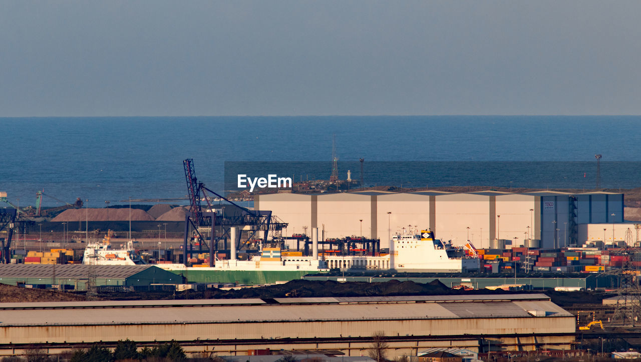 VIEW OF COMMERCIAL DOCK AGAINST SKY AT HARBOR