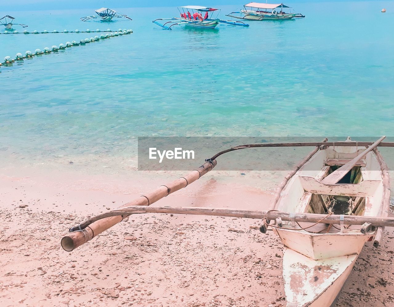 Outrigger boat moored at beach