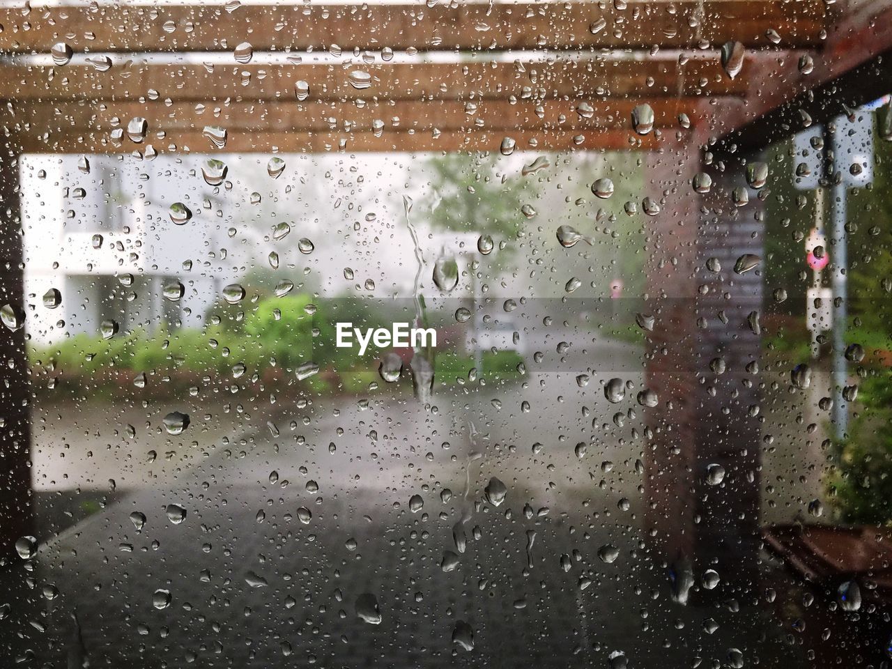 Street seen through wet glass window