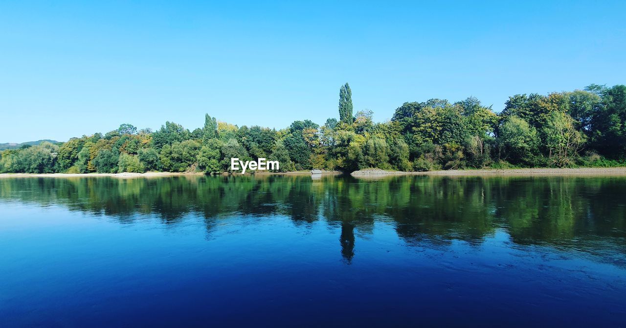 Scenic view of lake against blue sky