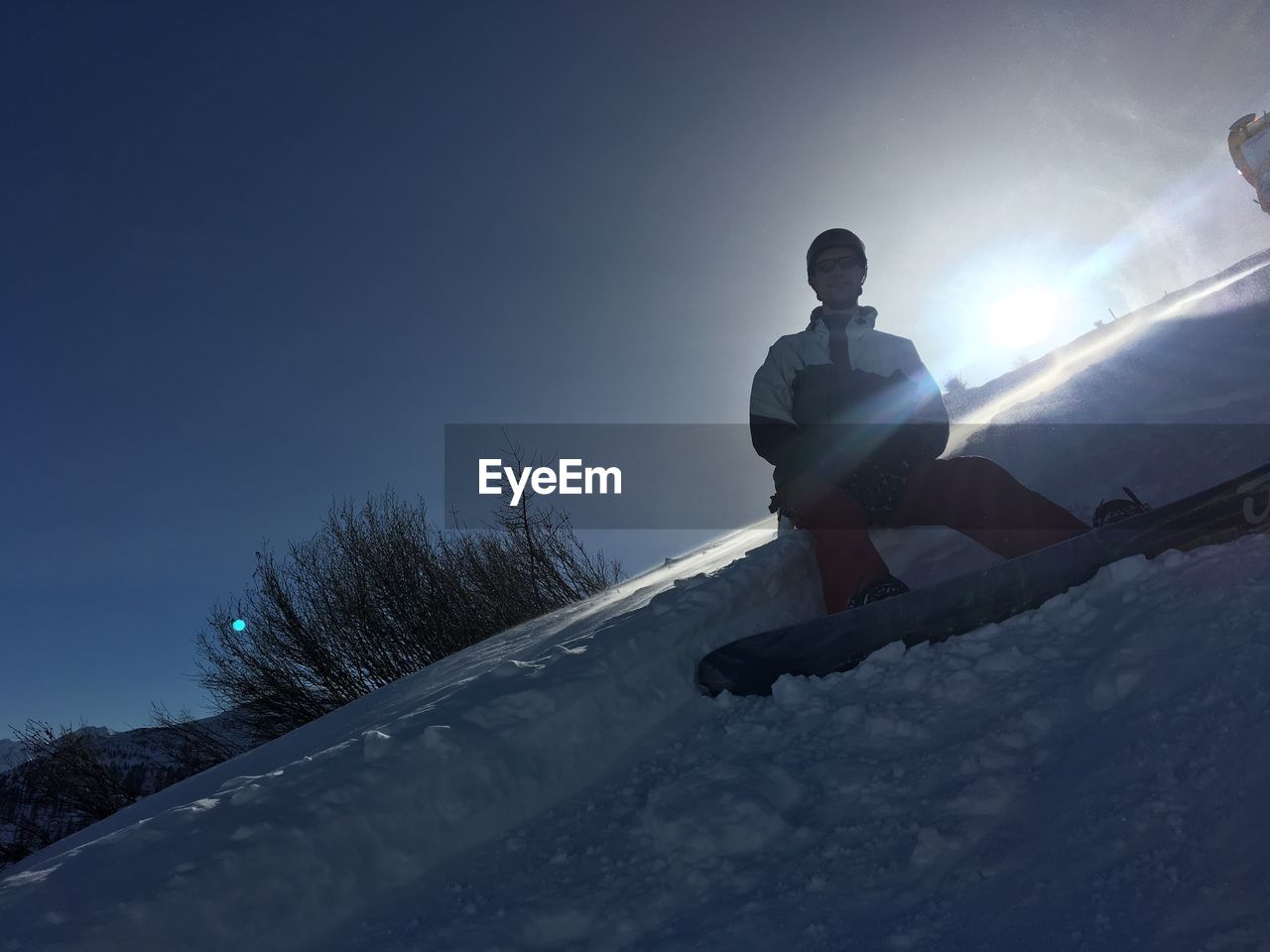 LOW ANGLE VIEW OF PERSON SKIING ON SNOW