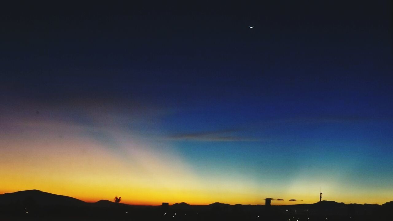 SILHOUETTE OF MOUNTAIN AGAINST SKY AT SUNSET