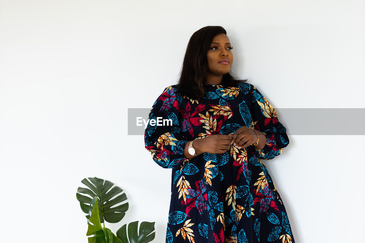 one person, women, adult, flower, white background, dress, clothing, studio shot, photo shoot, indoors, fashion, portrait, three quarter length, spring, copy space, standing, pattern, female, young adult, hairstyle, traditional clothing, floral pattern, front view, sleeve, looking, plant, lifestyles, waist up, nature, kimono, costume, black hair, smiling