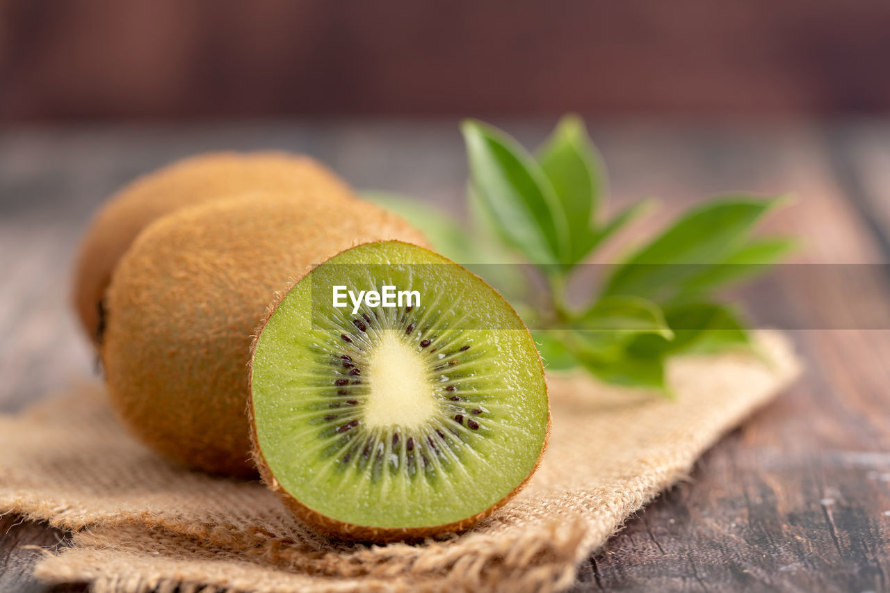 A half of fresh green kiwi on the old wooden