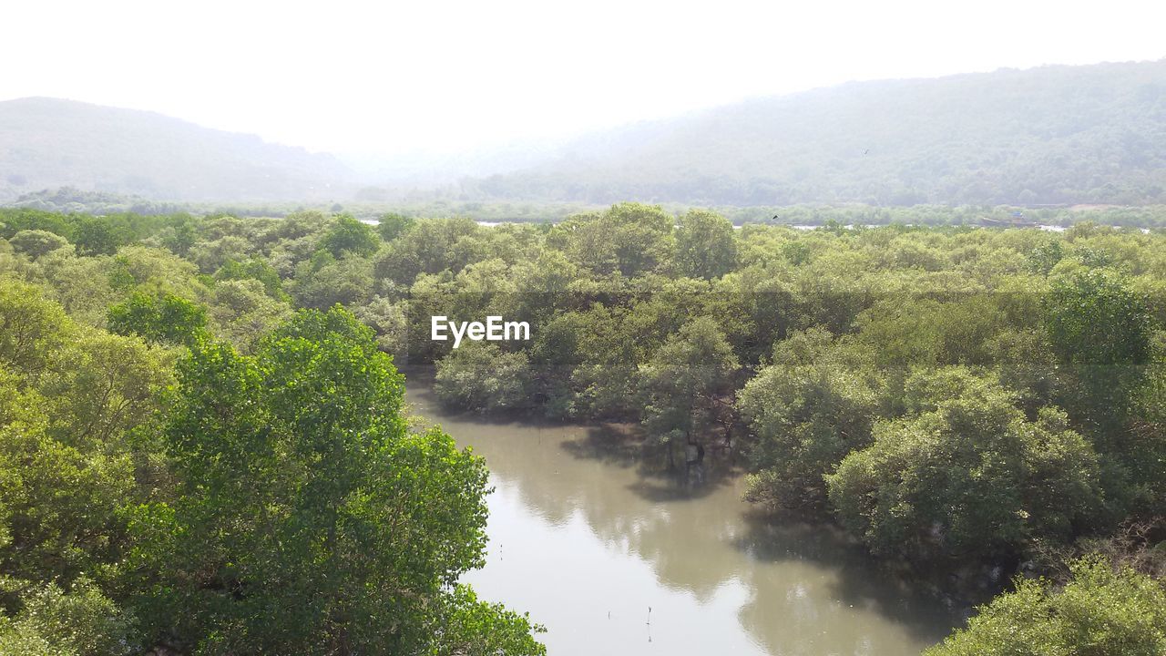 SCENIC VIEW OF RIVER WITH MOUNTAINS IN BACKGROUND