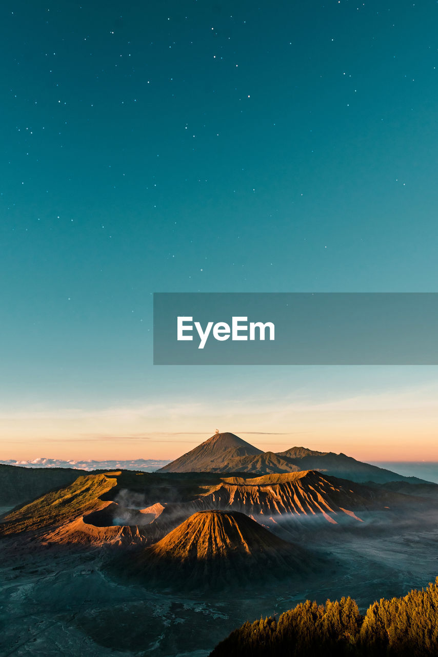 Scenic view of mountains against sky at dusk