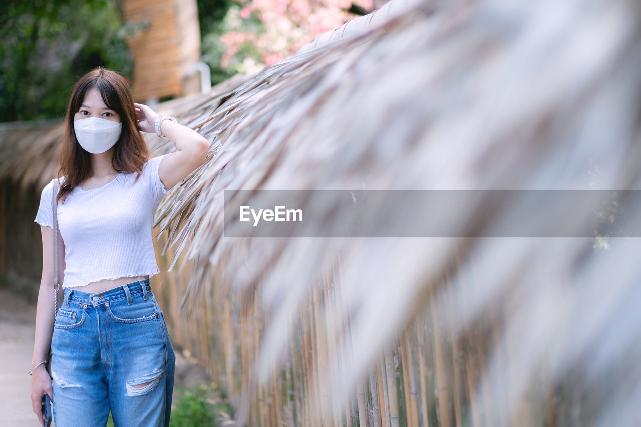 portrait of young woman standing in forest