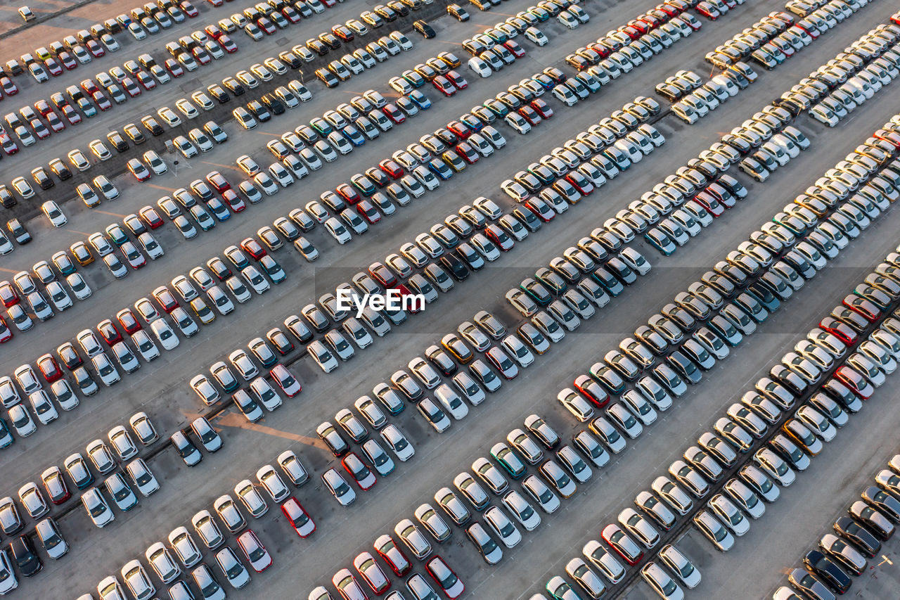 Aerial view of brand new cars at the logistics center, near the factory. car parking lot.