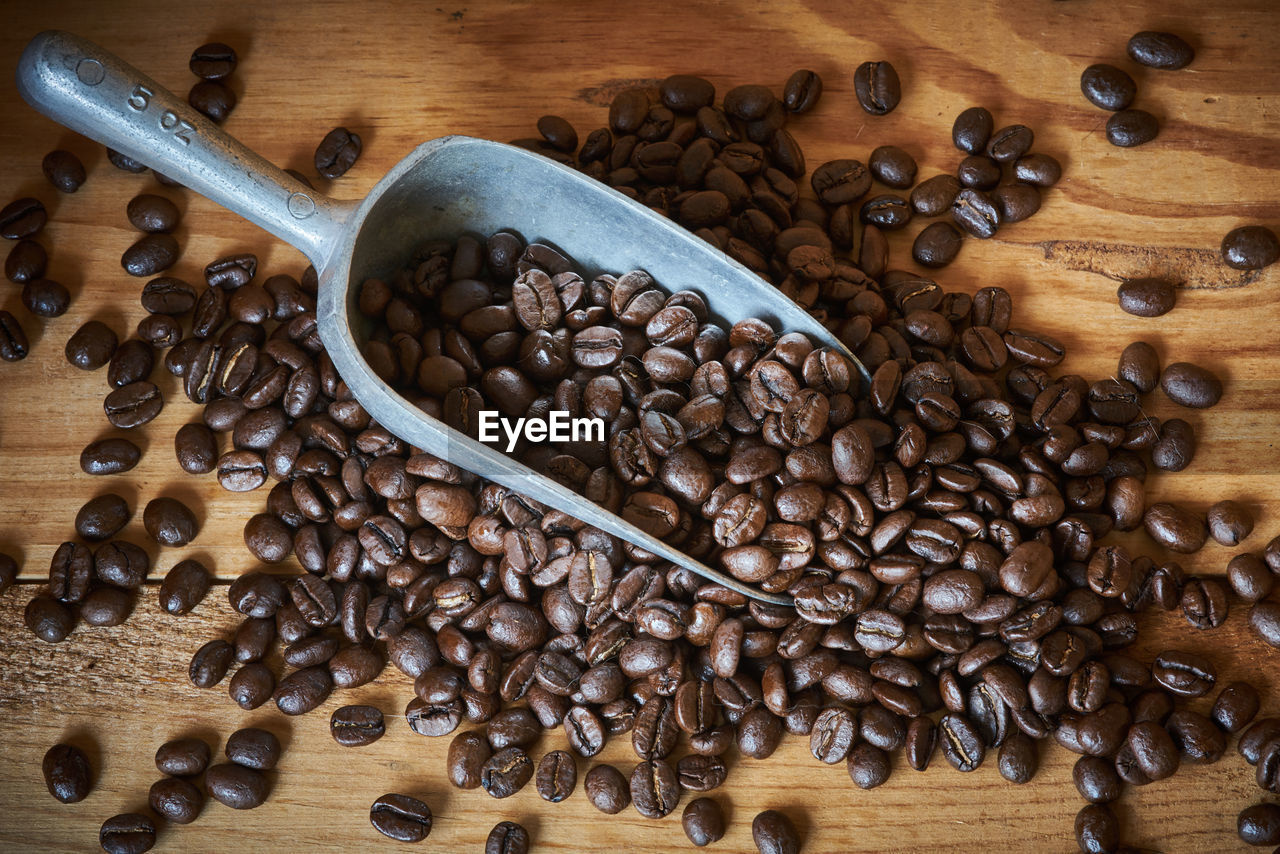 High angle view of roasted coffee bean spilled from spoon