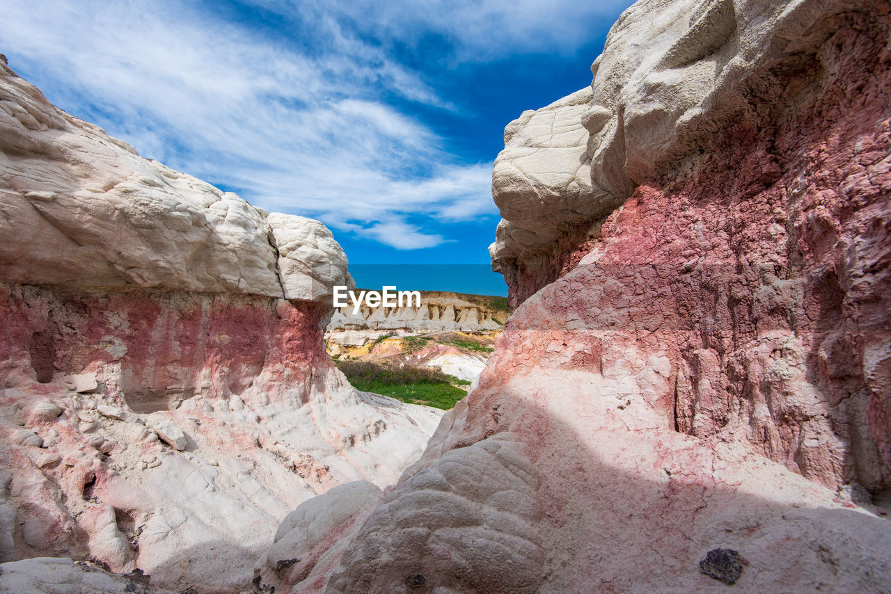 Landscape of pink, orange and white rock formations at interpretive paint mines in colorado