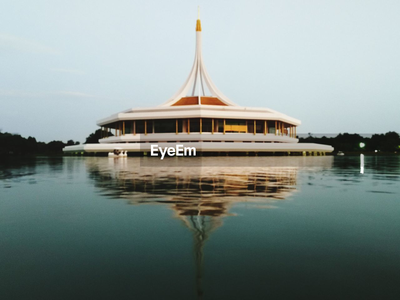 Pavilion reflecting on calm lake at suan luang rama ix