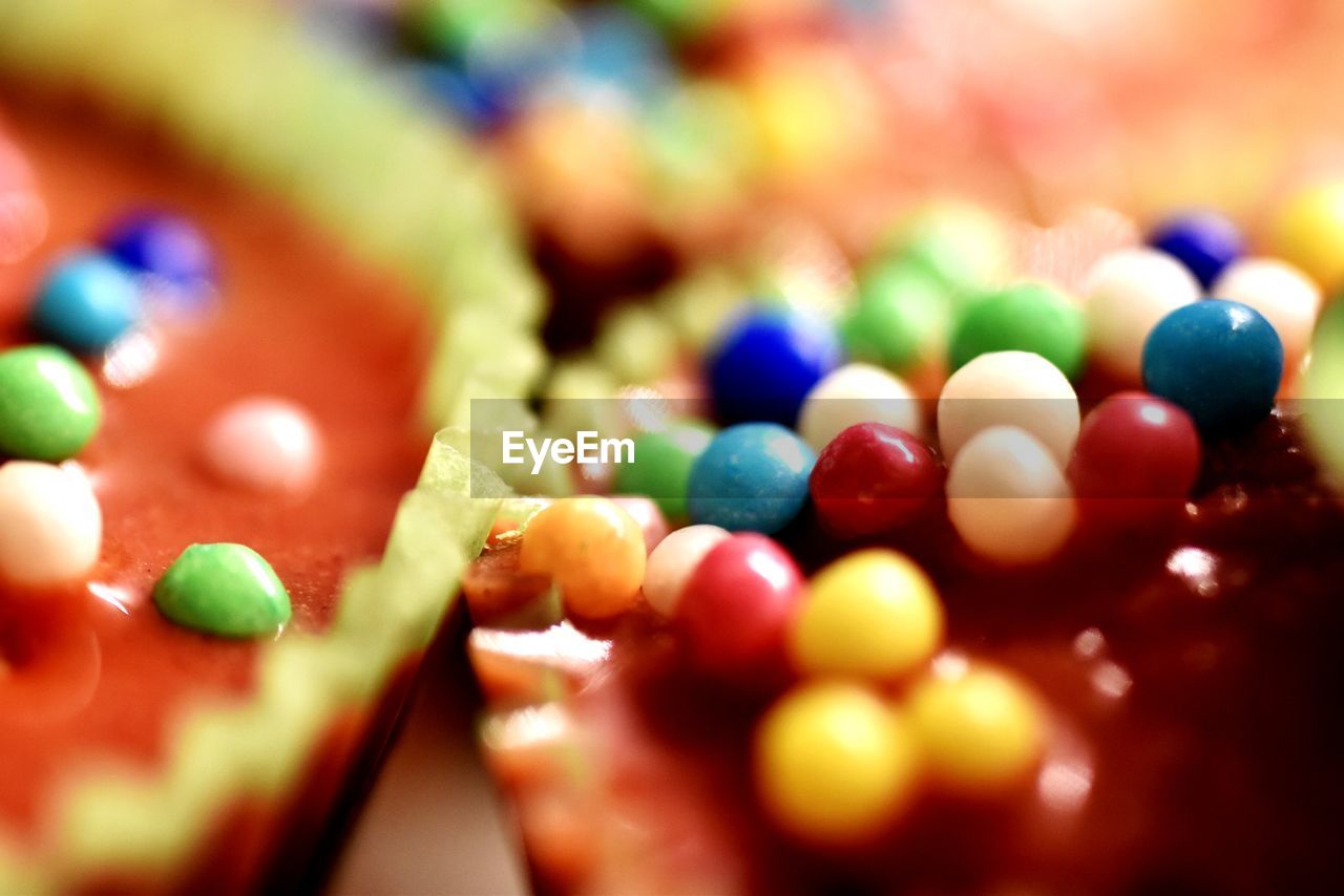 CLOSE-UP OF MULTI COLORED CANDIES IN CONTAINER