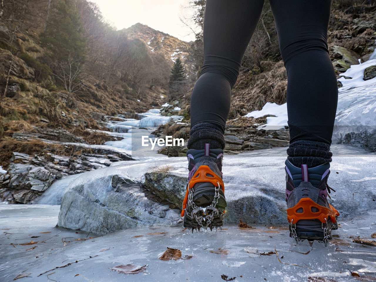 Trekking boots on an iced river