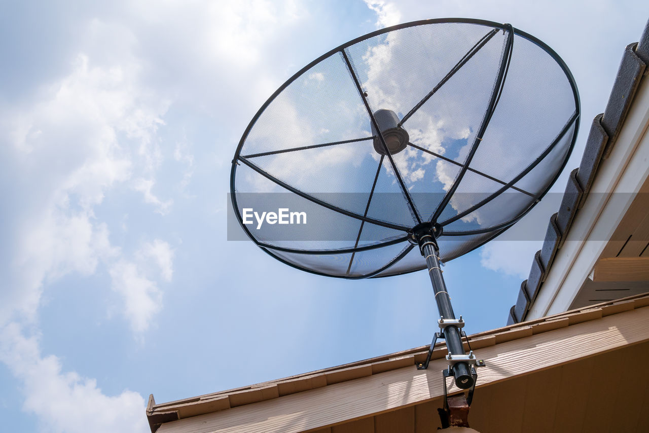 Satellite dish on house roof, satellite communication technology