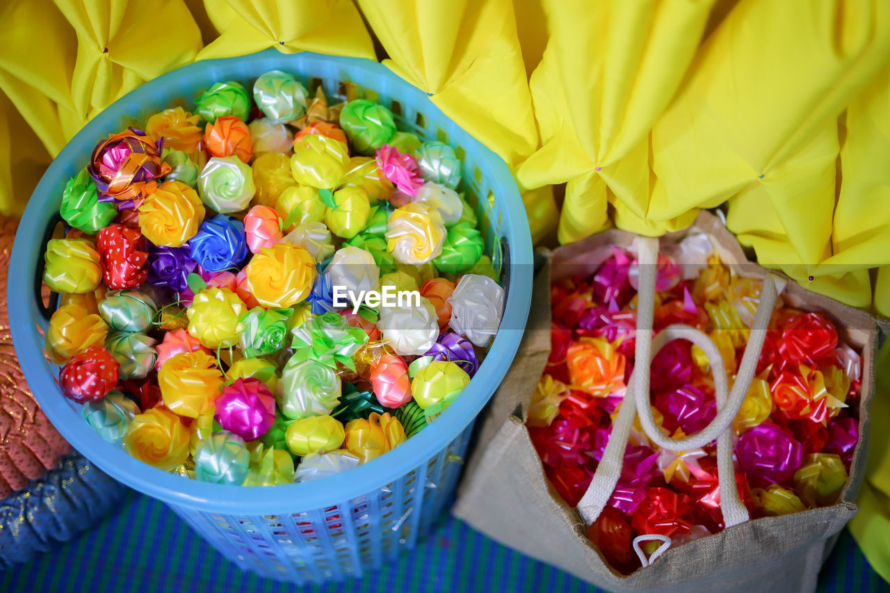 food and drink, food, multi colored, freshness, healthy eating, fruit, variation, high angle view, sweet food, container, flower, dessert, no people, abundance, sweet, wellbeing, snack, directly above, large group of objects, basket, sweetness, still life, yellow, indoors, bowl, produce, retail