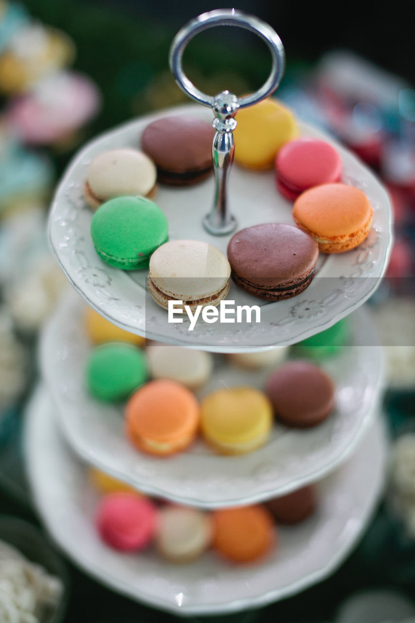 High angle view of fresh colorful macaroons on stand