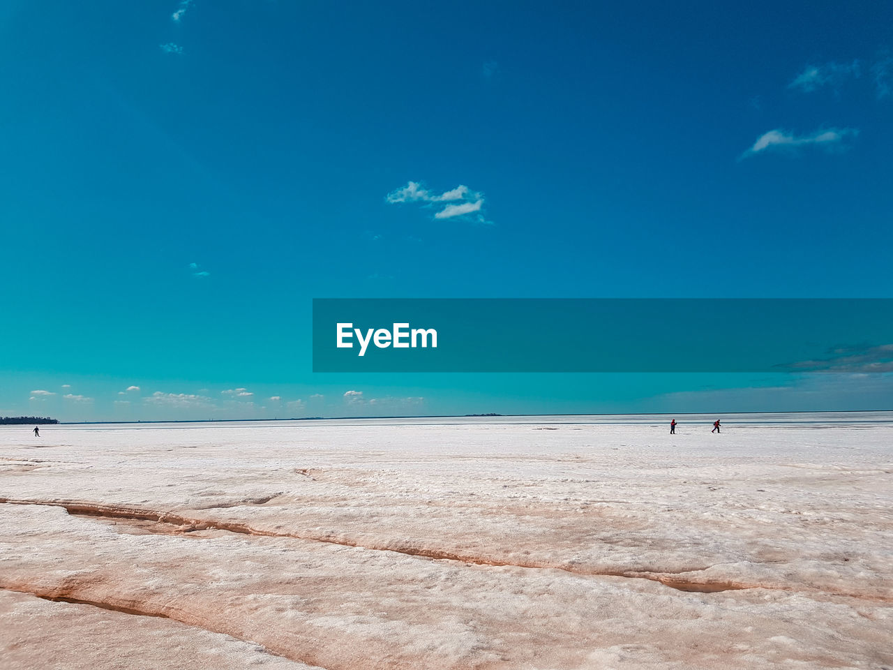 Scenic view of beach against blue sky