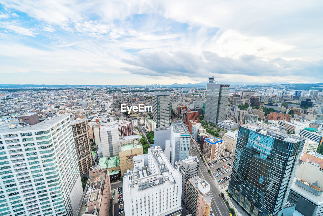 HIGH ANGLE VIEW OF MODERN BUILDINGS AGAINST SKY