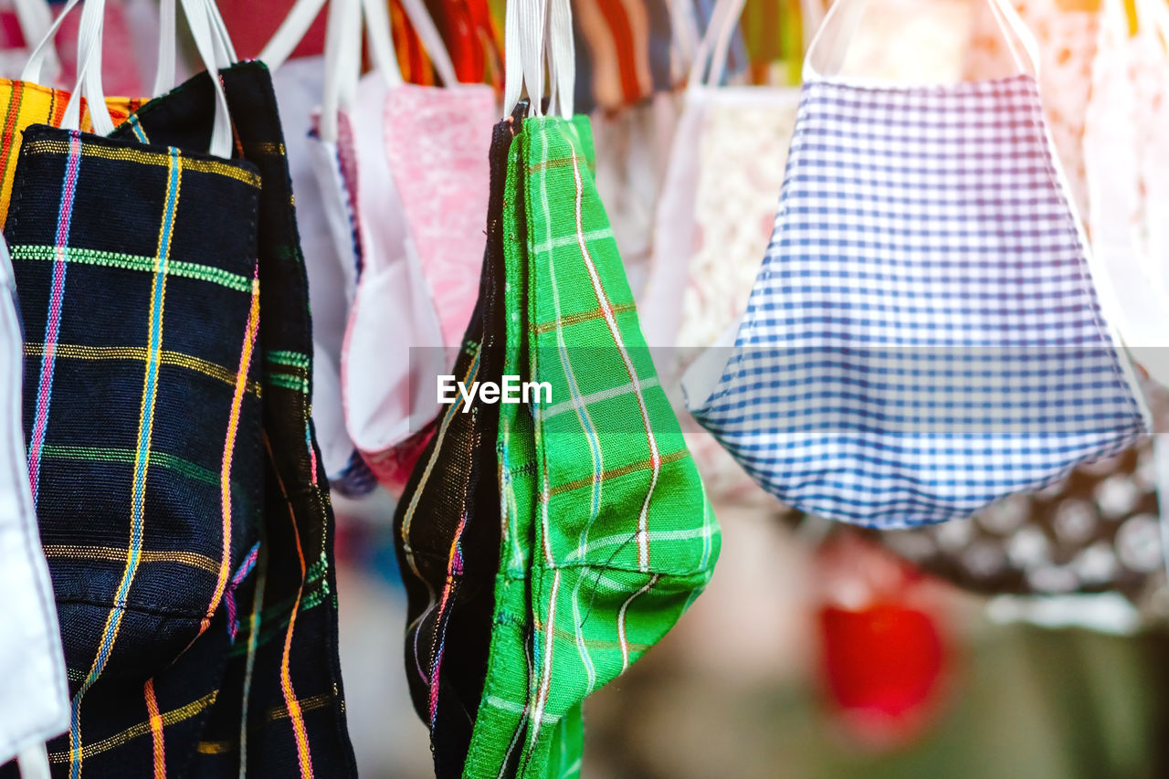 CLOSE-UP OF MULTI COLORED CLOTHESPINS HANGING