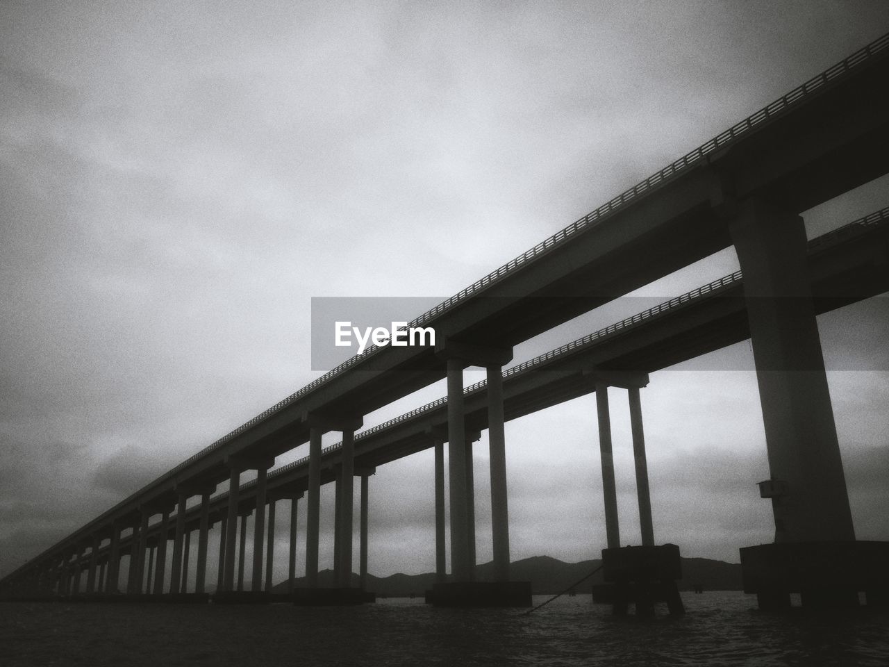 Low angle view of bridge over sea against sky