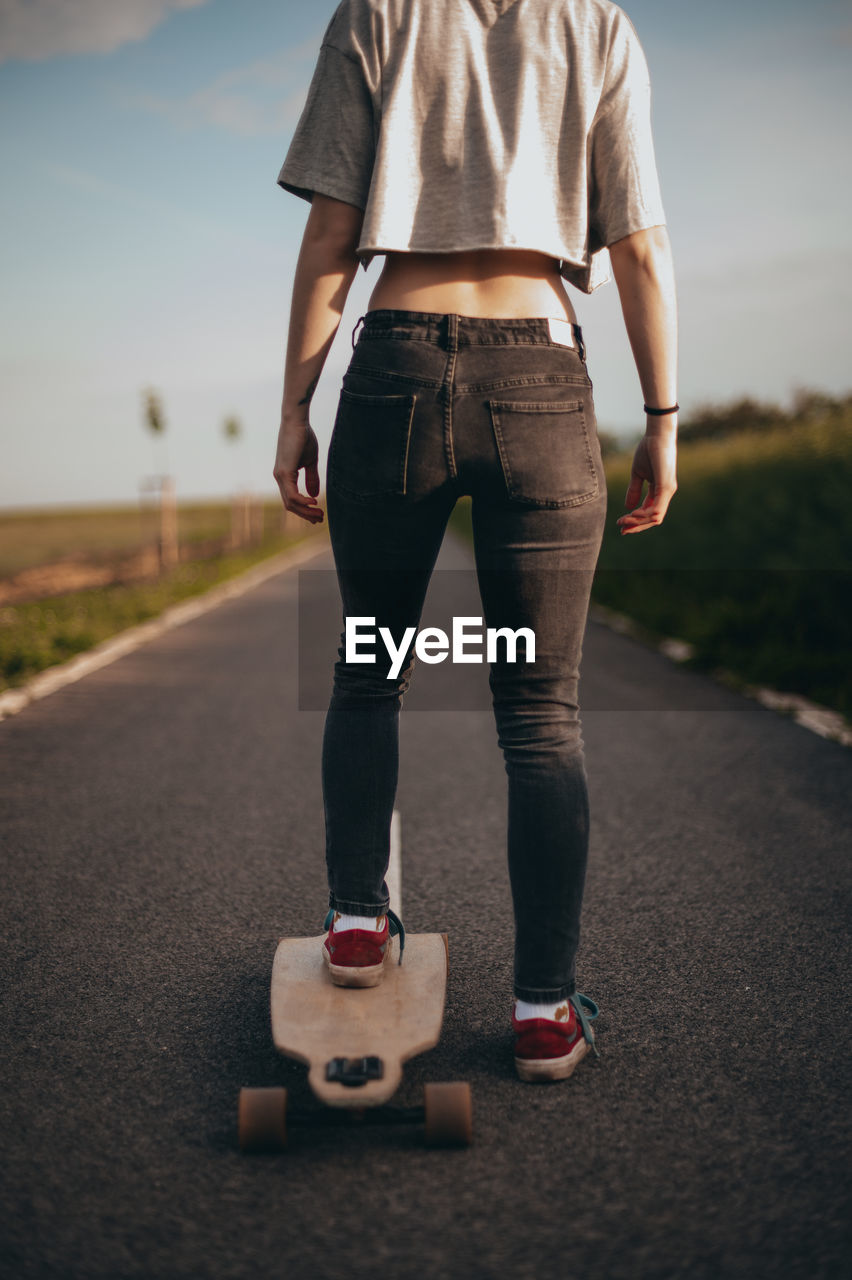 Low section of young woman on skateboard