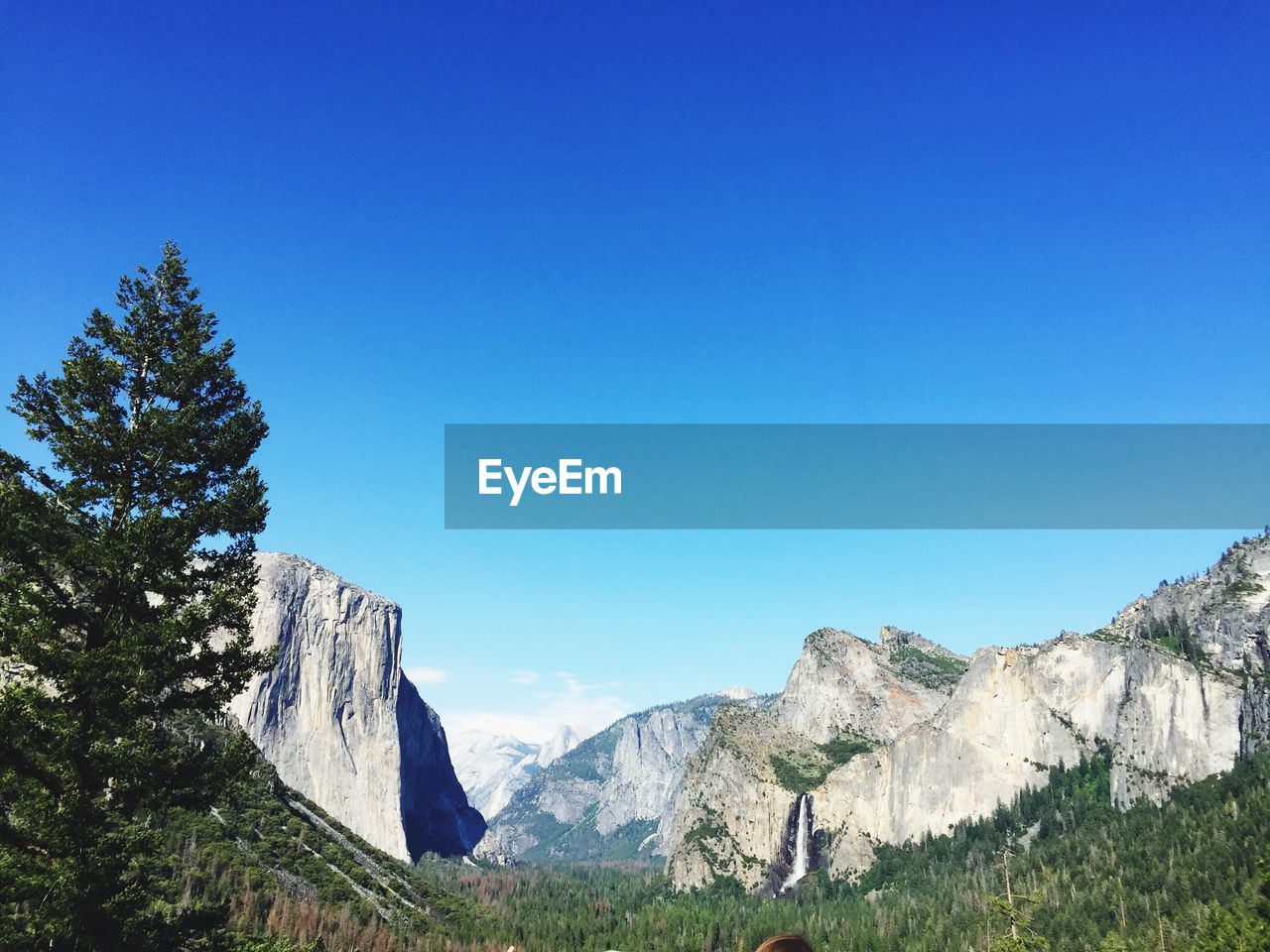 Scenic view of mountains against clear blue sky