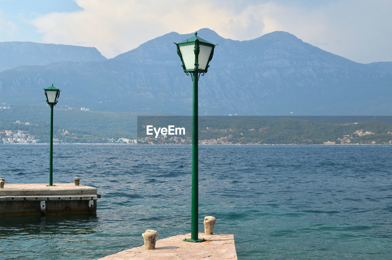 Green lanterns on docks with a sea view