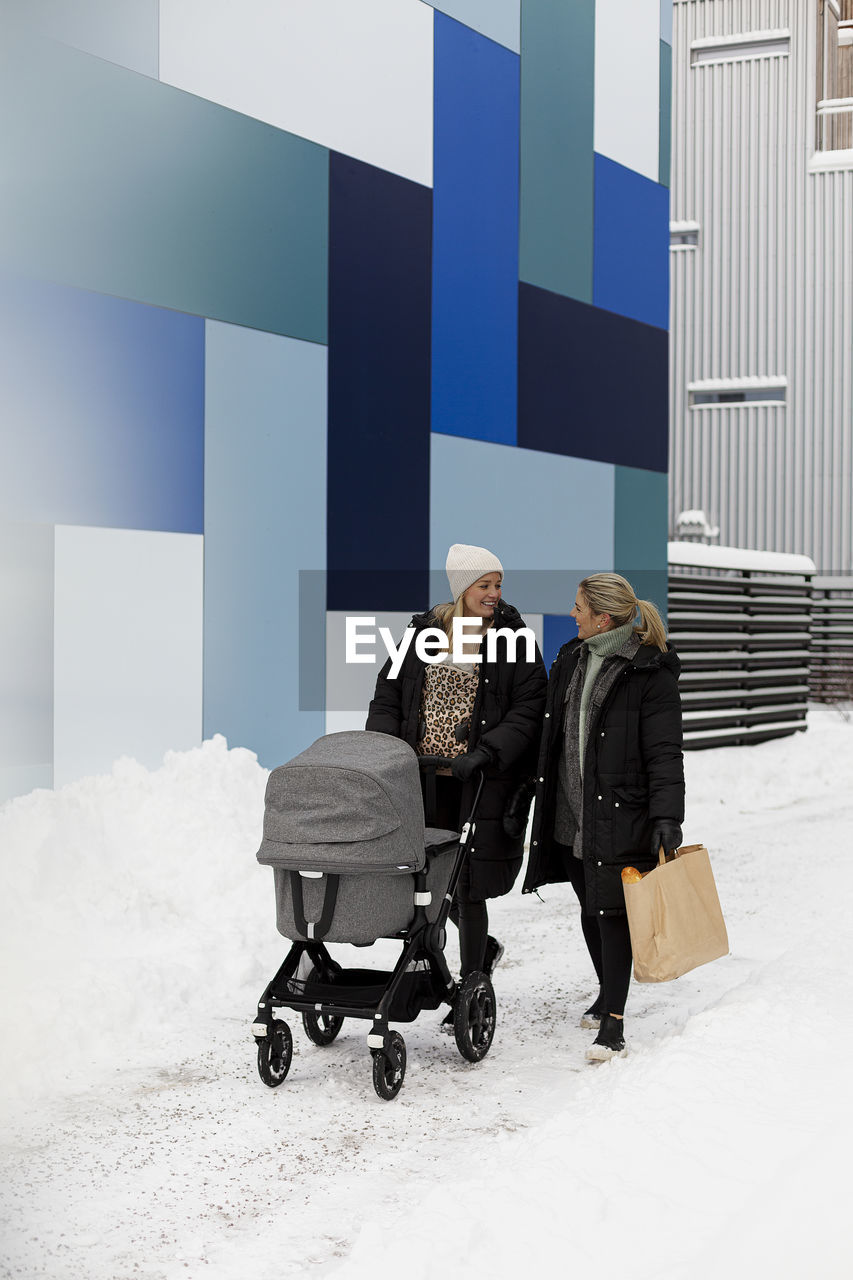 Female couple walking together at winter