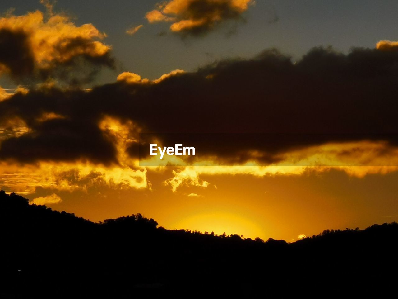 LOW ANGLE VIEW OF SILHOUETTE DRAMATIC SKY DURING SUNSET