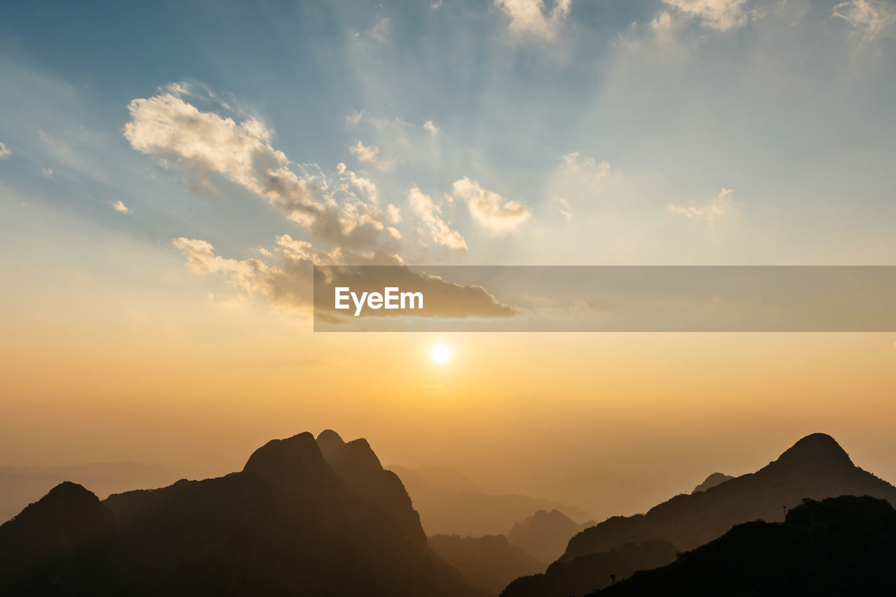 SILHOUETTE MOUNTAINS AGAINST SKY DURING SUNSET