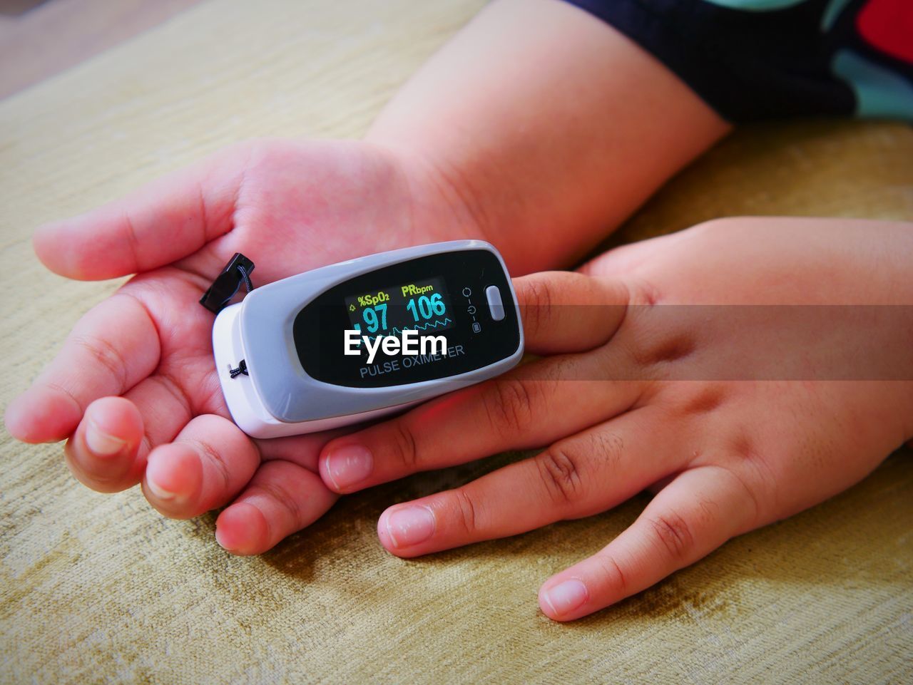 In the morning, the girl uses an oxygen and pulse monitor on her index fingertips.