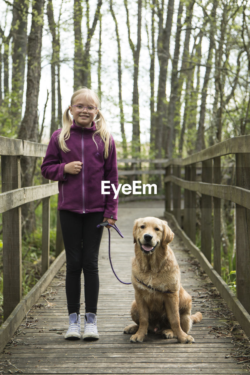 Full length of girl with dog