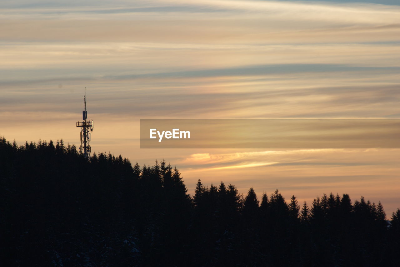 SILHOUETTE OF TOWER AGAINST SKY DURING SUNSET