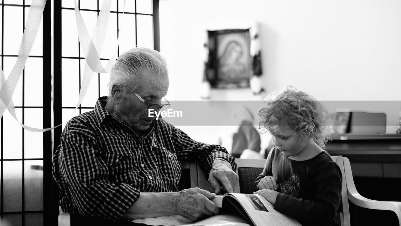 BOY SITTING ON SHELF AT HOME