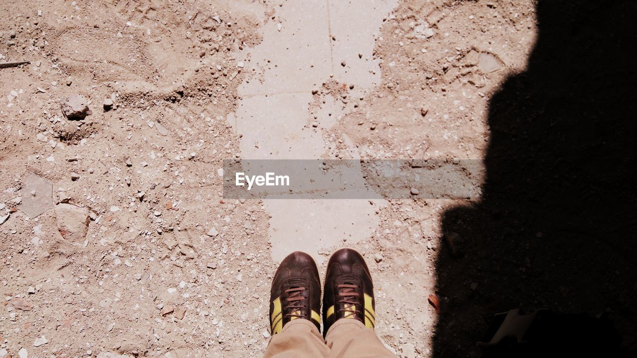 LOW SECTION OF WOMAN STANDING ON GROUND